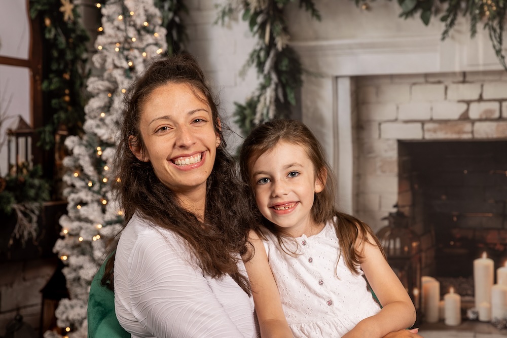 A picture of a mother and daughter smiling.