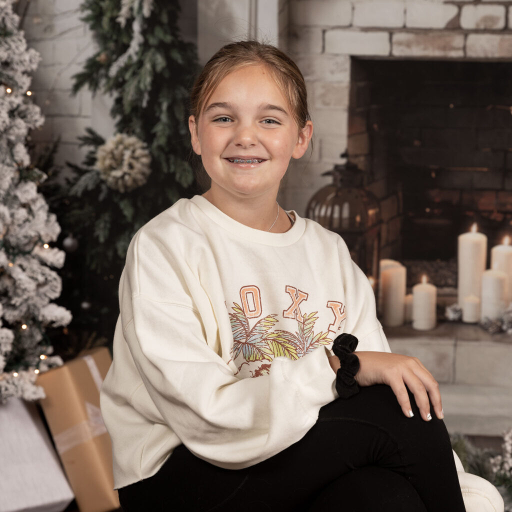 Young girl smiling at the camera.