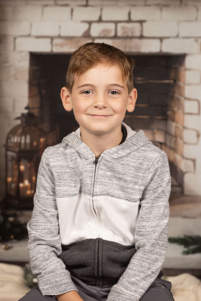 Young boy smirking at camera.