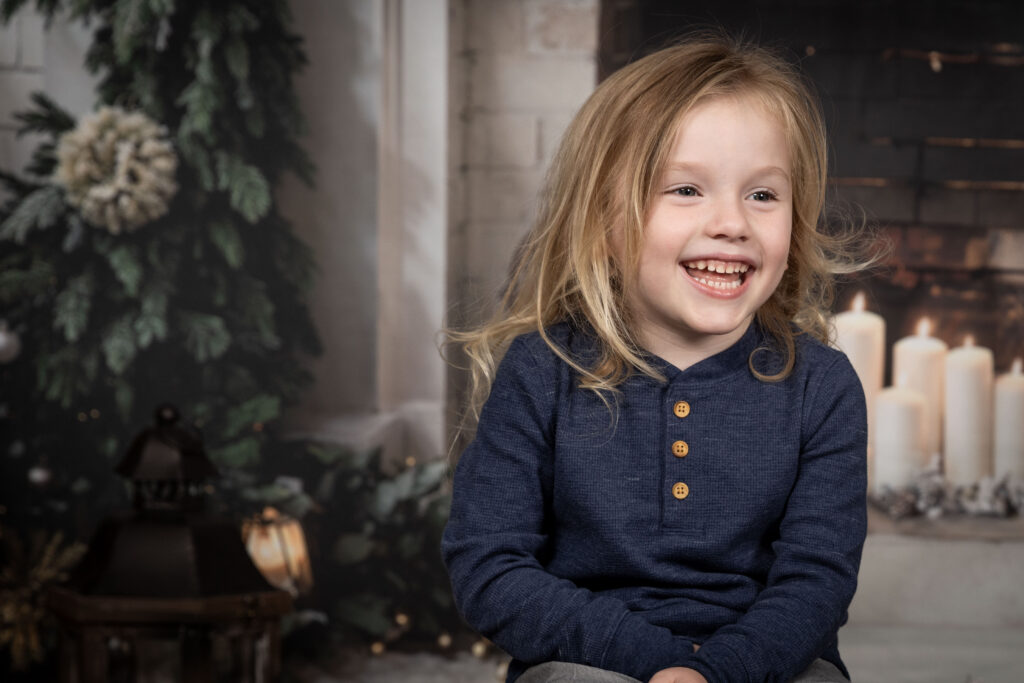 Young boy smiling off camera.