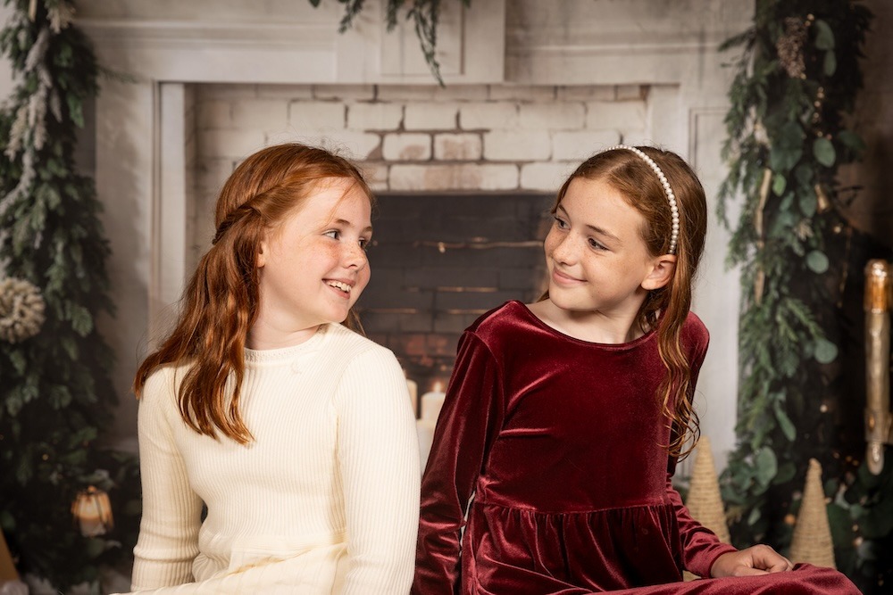 Two siblings smiling at each other.