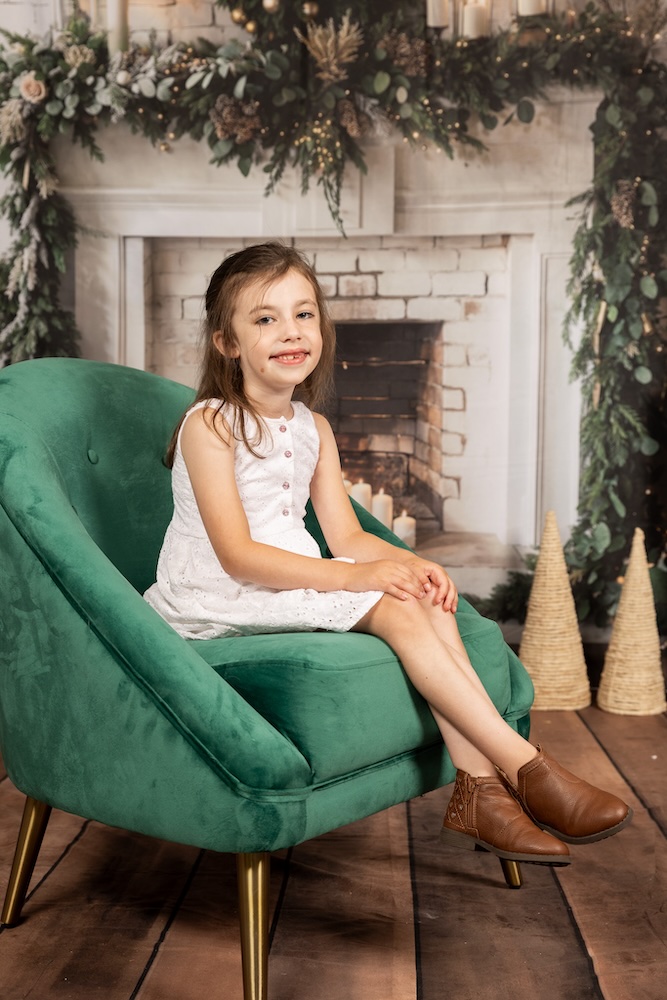 A child sitting in a green chair.