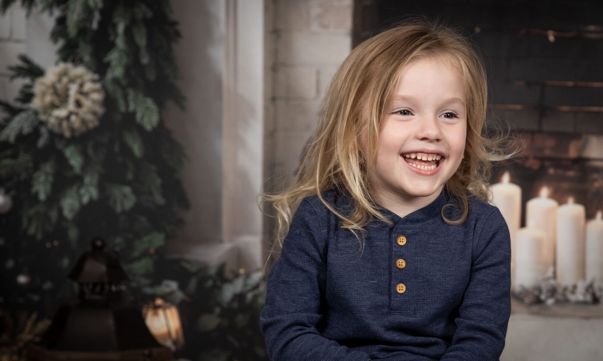 Young boy smiling off camera.