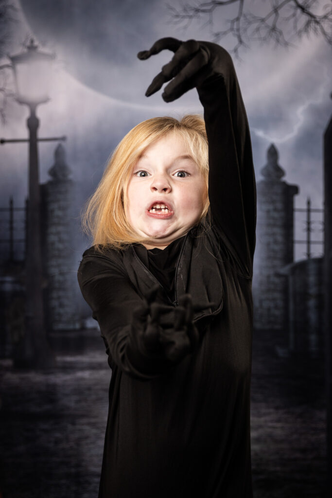 A young boy making a scary face.