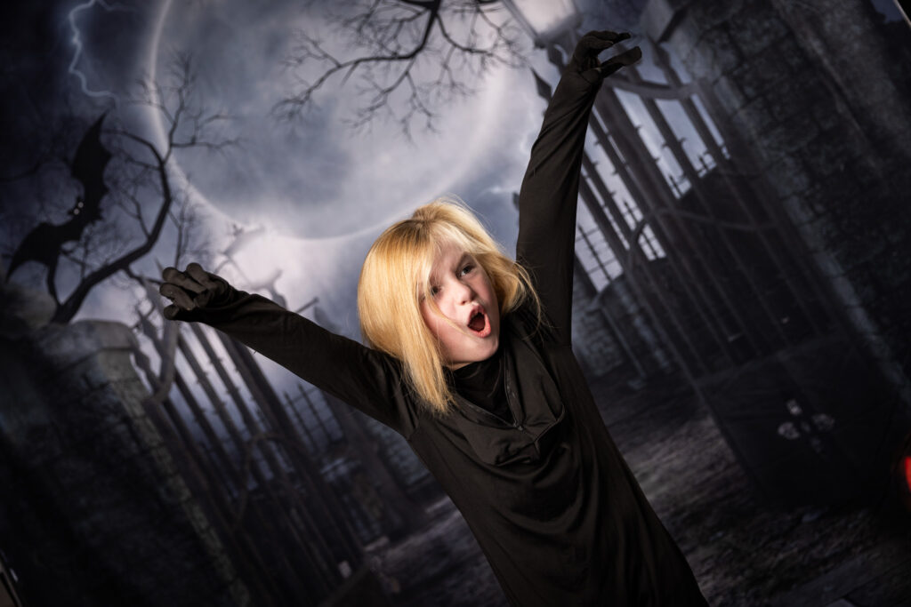 A young boy makes a scary face.