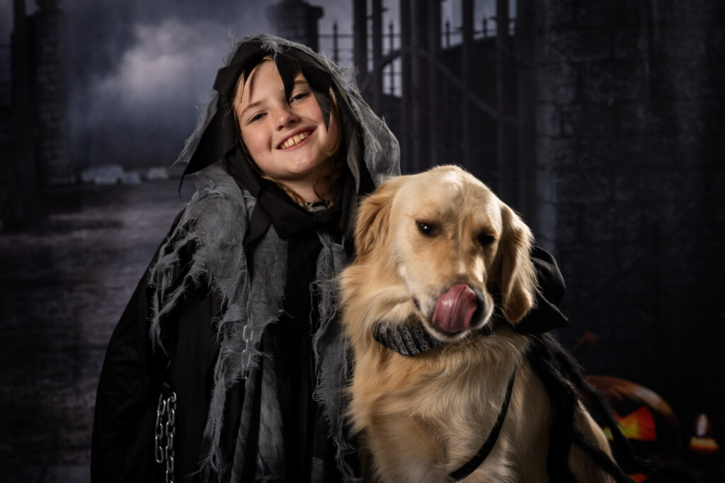 A boy and his dog posting for halloween photos.