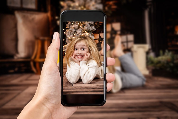 A photo of a person taking a portrait on a phone.