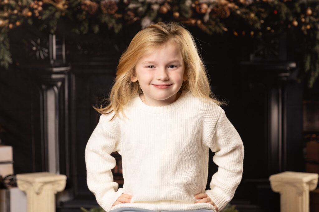 Woodlawn Studios Holiday Portraits Billerica MA 2025 youn boy smirking at camera.