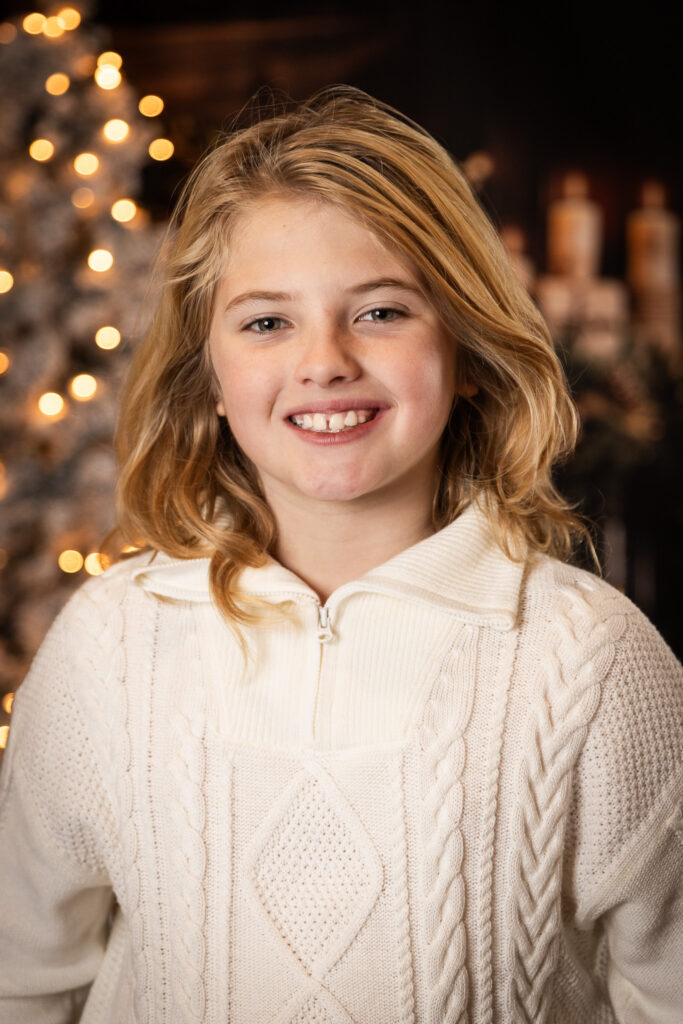 Woodlawn Studios Holiday Portraits Billerica MA 2025 young teen smiling with a white sweater.