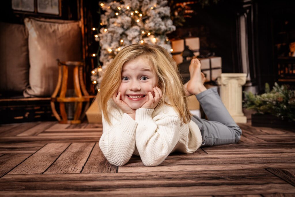 Woodlawn Studios Holiday Portraits Billerica MA Smiling Boy On Floor.