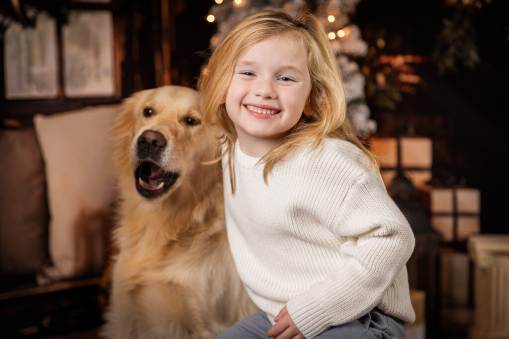 Woodlawn Studios Holiday Portraits Billerica MA 2025 young boy smiling with golden retriever dog pet.