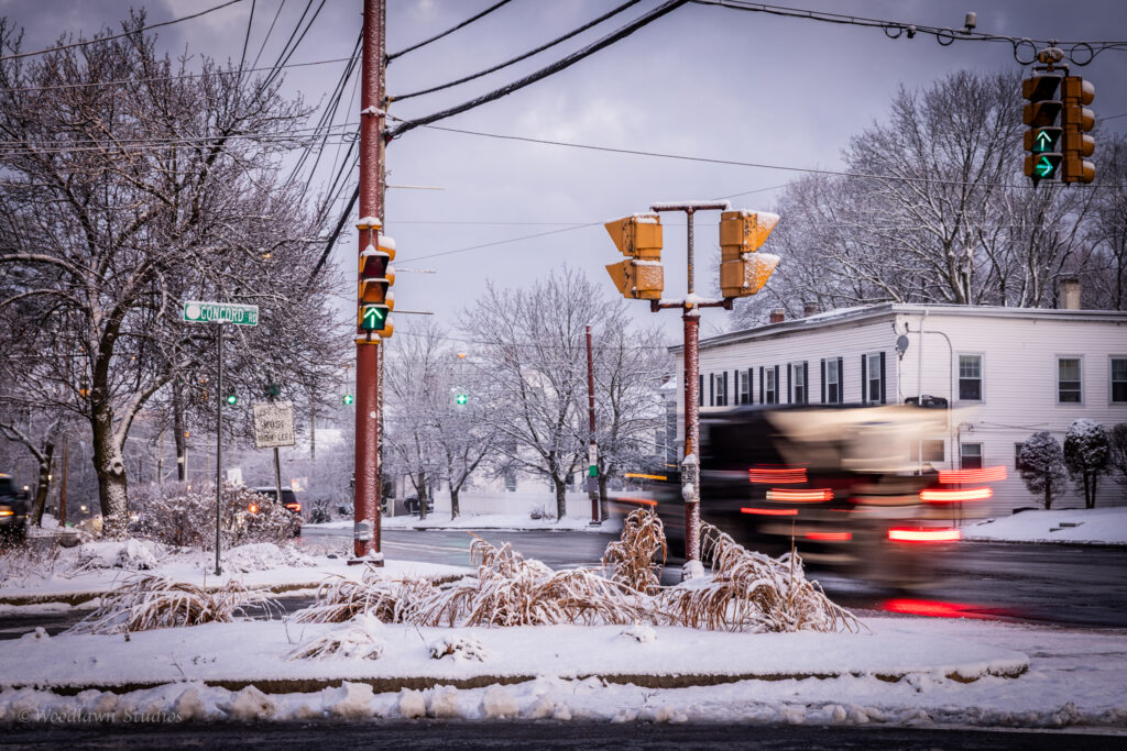 The salt truck drives through the intersection.